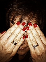 woman-hiding-behind-manicure